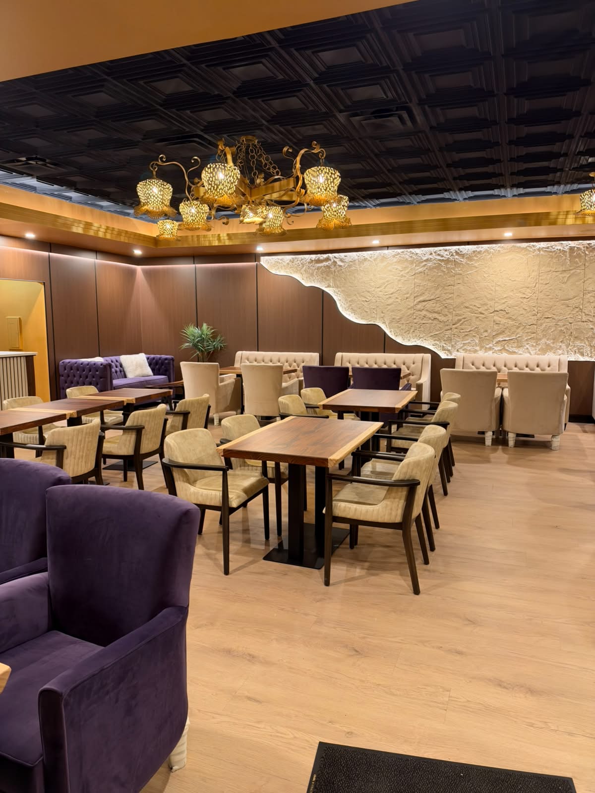 Warm lighting and gold trim over the café seating